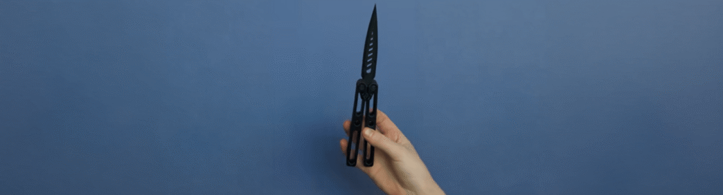 A hand demonstrates a 3D-printed butterfly knife as part of The Beam's investigation into untraceable weapons in Arizona schools