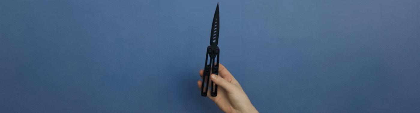 A hand demonstrates a 3D-printed butterfly knife as part of The Beam's investigation into untraceable weapons in Arizona schools