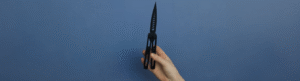 A hand demonstrates a 3D-printed butterfly knife as part of The Beam's investigation into untraceable weapons in Arizona schools