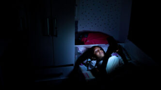 Storyblocks: Still Image of Teen Black Girl Using Cellphone Device At Night In Bed